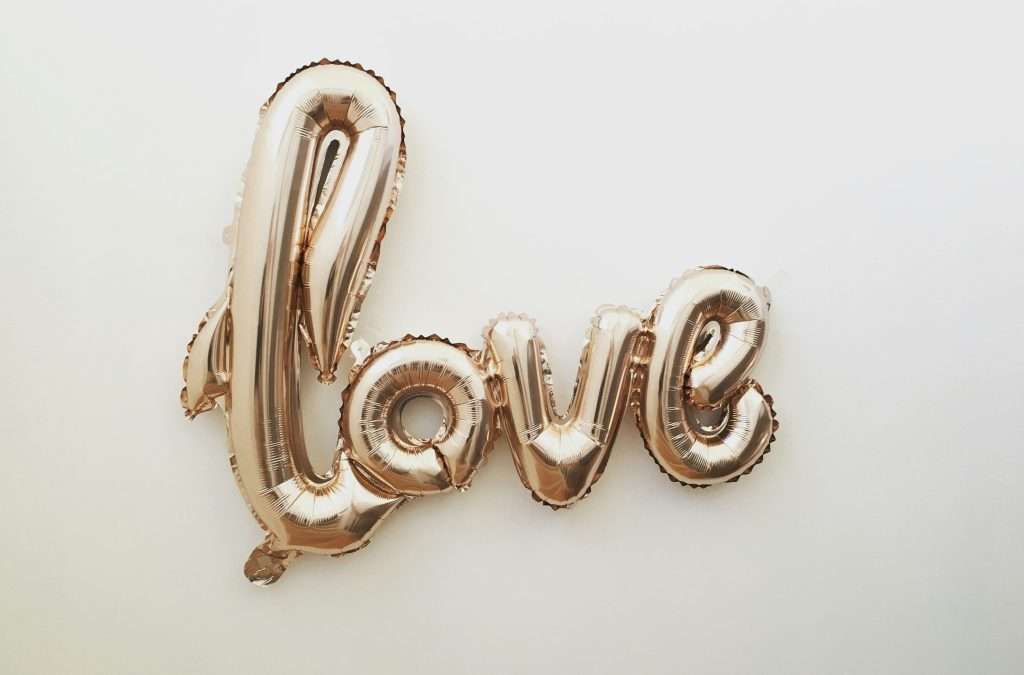 a gold balloon in the shape of a word